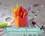 Bunte Papierfächer für Stiftehalter basteln. Mit Klebestift, Schere und vielen Stiften.