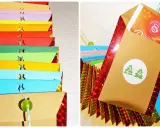 Bunte Umschläge für einen Tee Adventskalender selber machen. Kleine Sterne und Zahlen zieren die Päckchen.