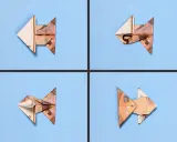 Vier gefaltete Geldscheine, die wie kleine Fische aussehen, schwimmen auf blauem Grund. Ein kreativer **fisch falten geld** Trick.