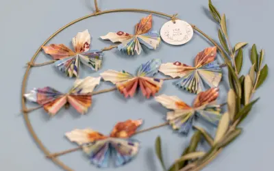 Kreative Deko: Viele bunte Schmetterlinge, gefaltet aus Geld, hängen an einem Ring. Ein schönes Geschenk, um Freude zu schenken.