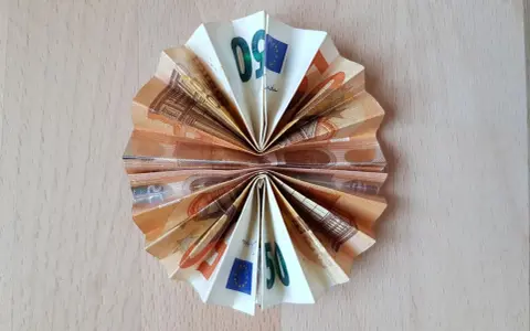 Gefaltetes Geld, das wie eine Socke aussieht, mit 50-Euro-Scheinen, die zu einem Fächer geformt sind.