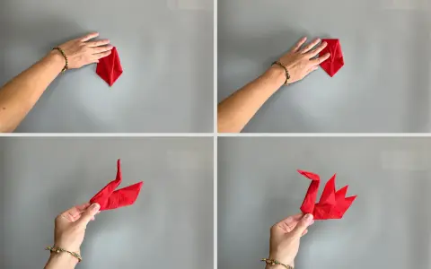 Schritt-für-Schritt-Anleitung: Servietten falten Schwan. Eine Hand formt eine rote Serviette zu einem eleganten Schwan.