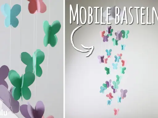 Bunte Schmetterlinge aus Papier hängen an Schnüren und bilden ein Mobile. Hier gibt es kostenlose mobile basteln vorlagen!