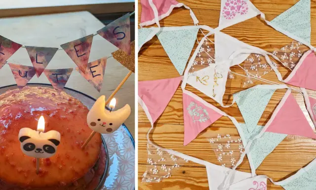 Geburtstagskuchen mit Kerzen und einer selbstgebastelten Papierkette. Daneben liegen weitere bunte Wimpelketten zum Basteln.