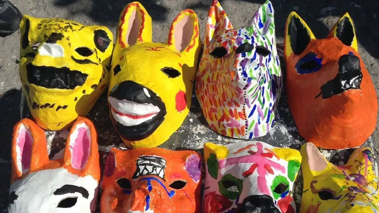 Bunte Pappmach&eacute;-Masken von Tieren, die an Luftballons erinnern, warten auf ihre Tr&auml;ger.
