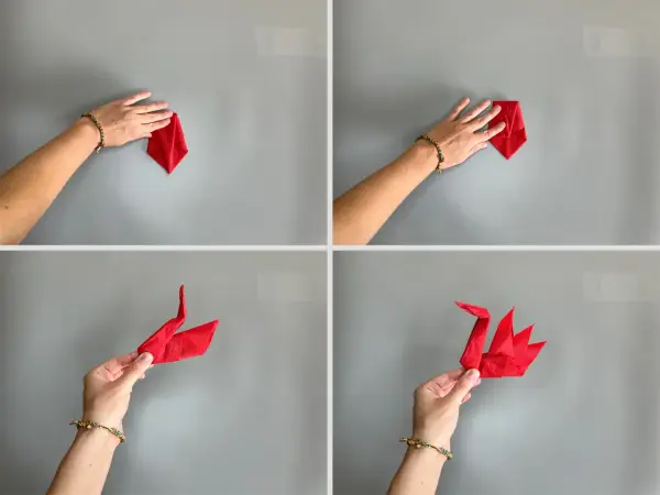 Schritt-für-Schritt-Anleitung: Servietten falten Schwan. Eine Hand formt eine rote Serviette zu einem eleganten Schwan.